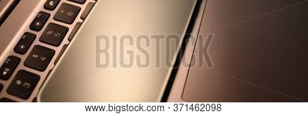 Silver Smartphone Lie On Laptop Keyboard In Office Close-up. Business Education Concept
