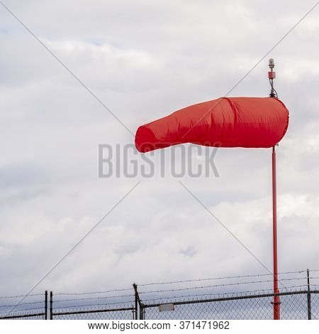 Square Red Wind Sock At An Airport Blowing In The Wind