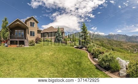 Panorama Frame Panorama Of The Backyard Of Home With Landscaped Grassy Lawn And Lush Plants