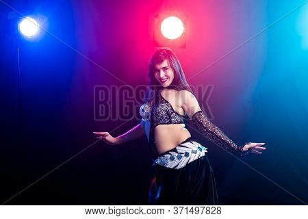 Girl Dancing Belly Dance, Fusion Or Tribal. A Woman In A Beautiful Costume Demonstrates Charming And