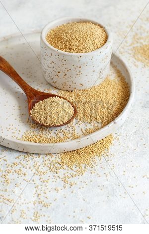 Bowl Of Raw Amaranth Grain With A Spoon Close Up On A White Table