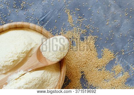Bowl Of Raw Amaranth Flour With A Spoon Of Amaranth Seeds On A Grey Table Top View