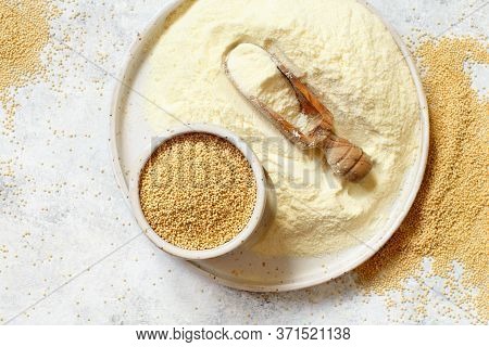 Plate Of Raw Amaranth Flour With A Scoop And Amaranth Seeds Top View