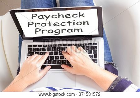 Someones Sitting Om Chair And Using Laptop, Paycheck Protection Program Concept