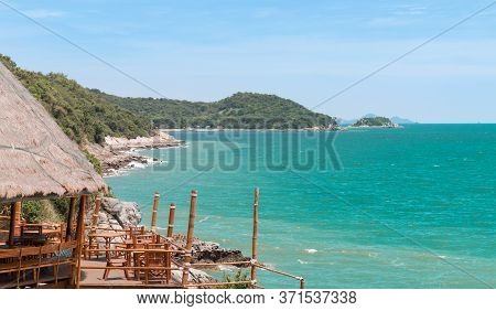 The Hut And The Sea With Emerald Green Water Amid The Blue Sky.
