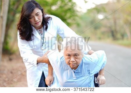 Doctor Help And Care Asian Senior Or Elderly Old Lady Woman Patient Sitting On Wheelchair At Park In