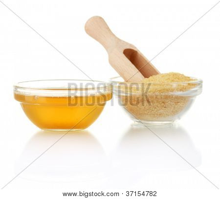 Gelatin in a bowl and wooden spoon isolated on white background close-up