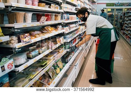 Bangkok, Thailand - June 15, 2020 : Asian Woman Shop Assistant Wearing Hygiene Face Mask Are Restock