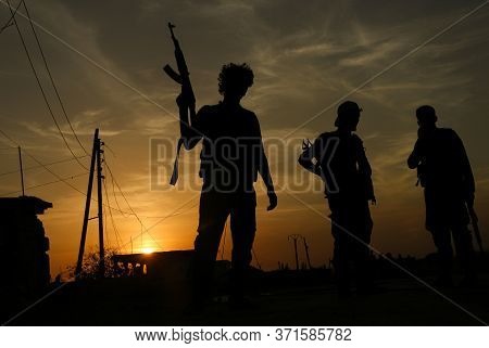A Warrior Carrying A Weapon After The Battle Is Over