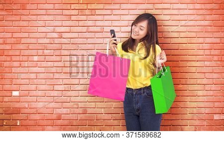Happy Asian Girl Resive Order In Paper Shopping Bag With Shopping Online By Smartphone In New Normal