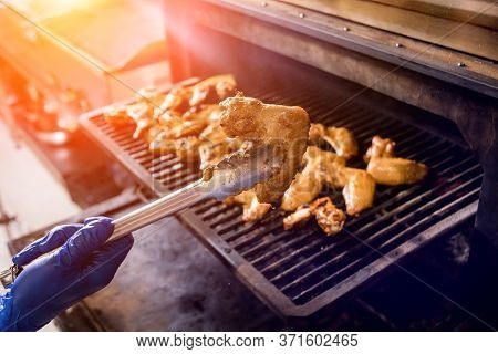 Fried Chiken Wings At Grill Barbecue. Restaurant.