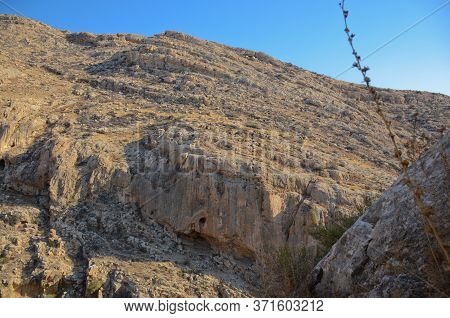 Wadi Kelt Or Nahal Prat, In The Judean Desert, Israel. View Of The Cliffs And Blue Sky From The Cave