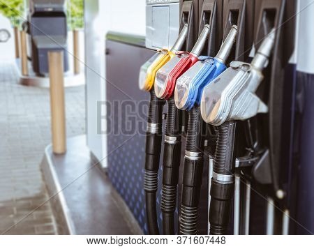 Petrol Gas Station With Colorul Fuel Gasoline Dispensers Background. Gas Nozzle Pumps.