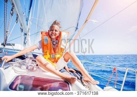 Little Boy On Board Of Sailing Yacht On Summer Cruise. Travel Adventure, Yachting With Child On Fami