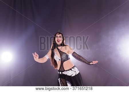 Girl Dancing Belly Dance, Fusion Or Tribal. A Woman In A Beautiful Costume Demonstrates Charming And
