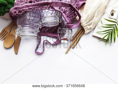 Cotton Bags, Net Bag With Reusable  Glass Jars, Bamboo And Wooden Cutlery On White Background. Zero 