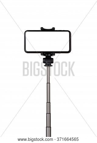 Smartphone With A White Cut-out Screen On A Monopod. Selfie Stick And Smartphone On A White Backgrou
