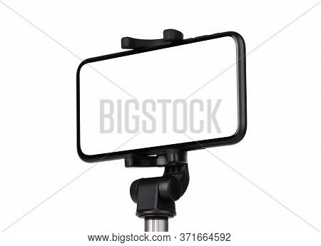 Smartphone With A White Cut-out Screen On A Monopod. Selfie Stick And Smartphone On A White Backgrou