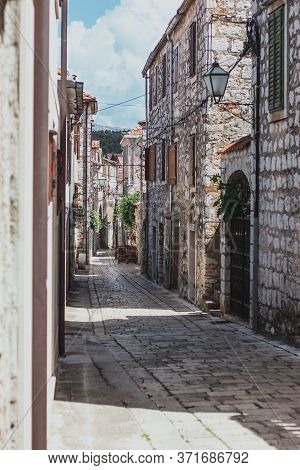 Narrow Old Streets In The Town Of Starigrad On The Island Hvar. Old Greek Style Stone Houses And A N