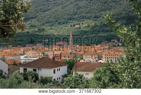 View Of The Old House Roofs Of The Town Of Starigrad On The Island Of Hvar. Church Belltower Rising 