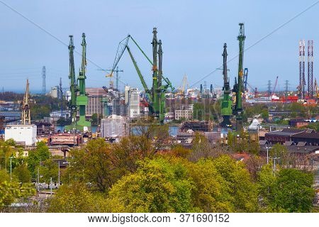 Harbor Cranes At The Famous Shipyard Of Gdansk On A Sunny Day. Poland.