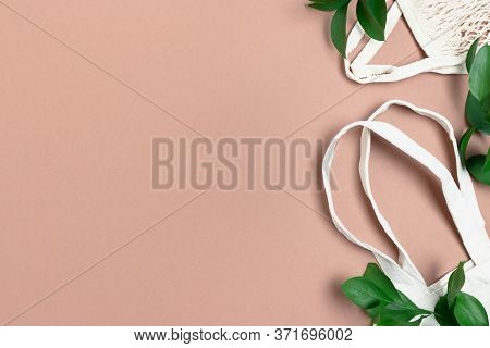 Ruscus Branches And Reusable Shopping Bags. Plastic Free Concept With Copy Space.