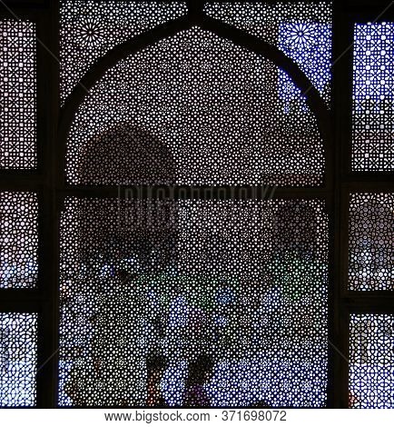 People Behind Lattice Craft Window Mosque Sunny Day