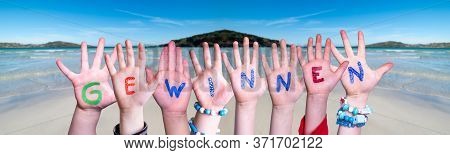 Children Hands Building Word Gewinnen Means Win, Ocean Background