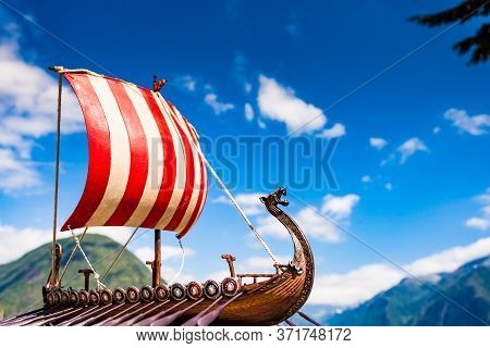Old Wooden Viking Longboat Sails, Drakkar Boat On Fjord Shore In Norway. Tourism And Traveling Conce