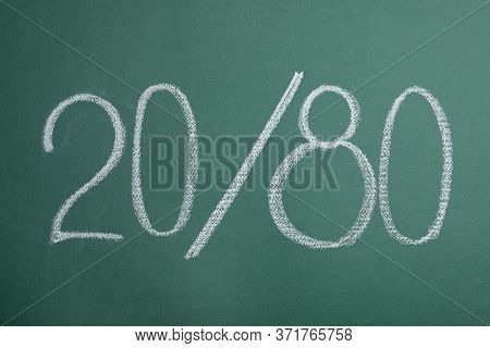 Numbers 20 And 80 Written With Chalk On Green Background. Pareto Principle Concept