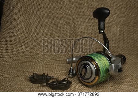 Fishing, Carp Reel With Fishing Linel On The Background Of Burlap . Burlap
