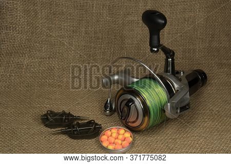 Fishing, Carp Reel With Fishing Linel On The Background Of Burlap . Burlap