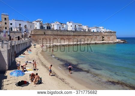 Monopoli, Italy - May 29, 2017: People Visit Monopoli Beach In Apulia, Italy. With 50.7 Million Annu