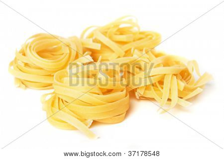 Tagliatelle pasta nest isolated on white background