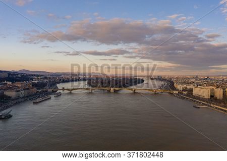 Aerial Drone Shot Of Margaret Bridge Over Danube River In Budapest Sunset Hour