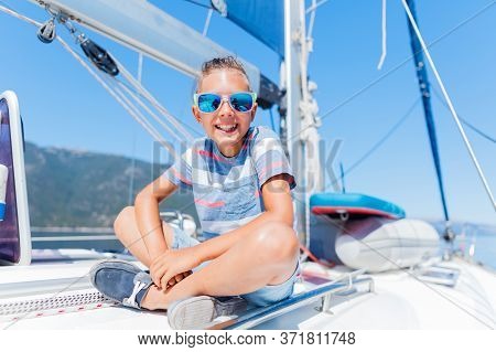 Little Boy On Board Of Sailing Yacht On Summer Cruise. Travel Adventure, Yachting With Child On Fami