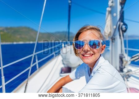 Little Boy On Board Of Sailing Yacht On Summer Cruise. Travel Adventure, Yachting With Child On Fami
