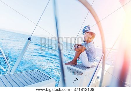 Little Boy On Board Of Sailing Yacht On Summer Cruise. Travel Adventure, Yachting With Child On Fami