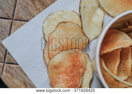 Fresh Homemade Deep Fried Crispy Potato Chips In White Box On A Wooden Background, Top View. Salty C