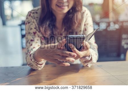 Asian Woman Using Smartphone Shopping Online Website On Smartphone With Smiling Face. Happiness Asia
