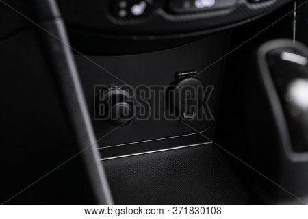 Close Up Of A Charging In The Car, Cigarette Lighter, Connectors. Modern Car Interior