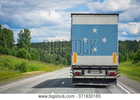 A  Truck With The National Flag Of Federal States Of Micronesia Depicted On The Back Door Carries Go