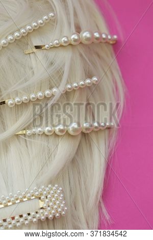 Pearl Hair Clips On Blond Hair Close-up. Fashionable Hair Accessories. Hairpin With Pearls On A Brig
