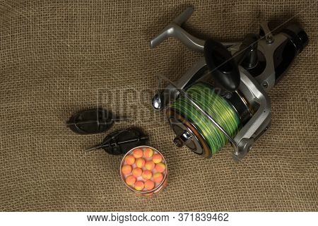 Fishing, Carp Reel With Fishing Linel On The Background Of Burlap . Burlap