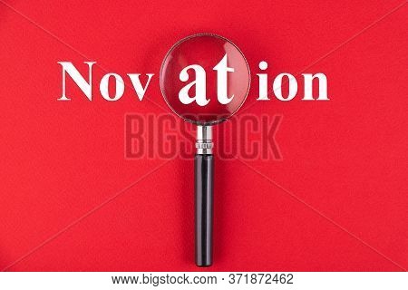 Novation Text Written Through A Magnifying Glass On A Red Background. Business Education Concept.