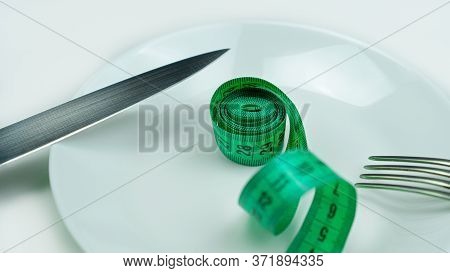 Tape Measure On Plate Remind You Of Proper Nutrition And A Beautiful Figure.