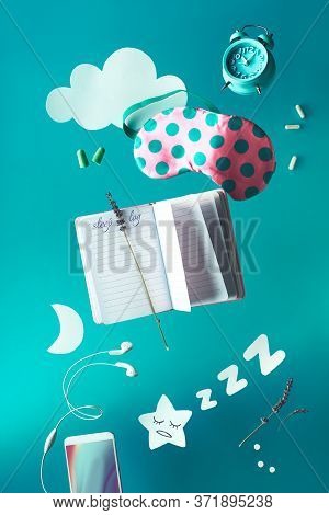 Healthy Night Sleep Creative Concept With Sleep Log Handwritten Diary. Flying Or Levitating Objects: