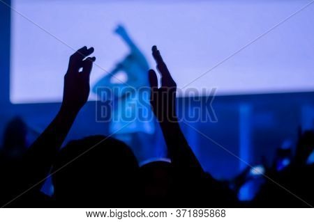 Man Silhouette Partying, Cheering, Raising Hands Up And Clapping At Rock Concert In Front Of Stage O