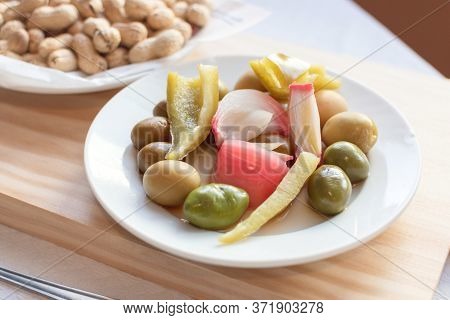 Olives Pepper And Peanuts On A Plate