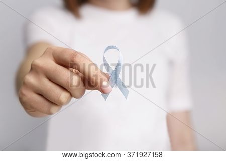 National Child Abuse Prevention Month. Light Blue Awarness Ribbon In Woman Hand, Men With Localised 